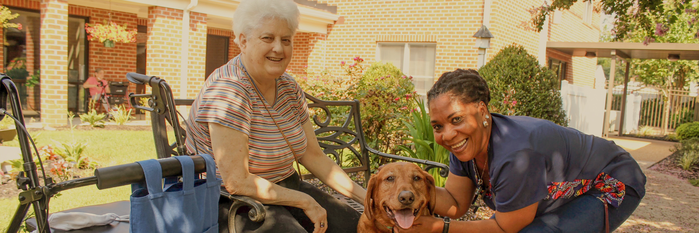 Resident with dog in courtyard